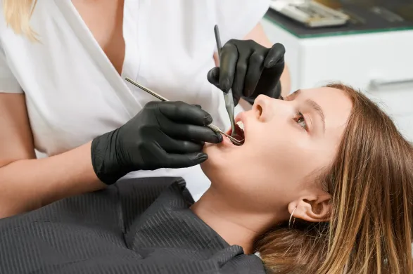 female-doctor-examining-patient-teeth-dental-clinic.webp